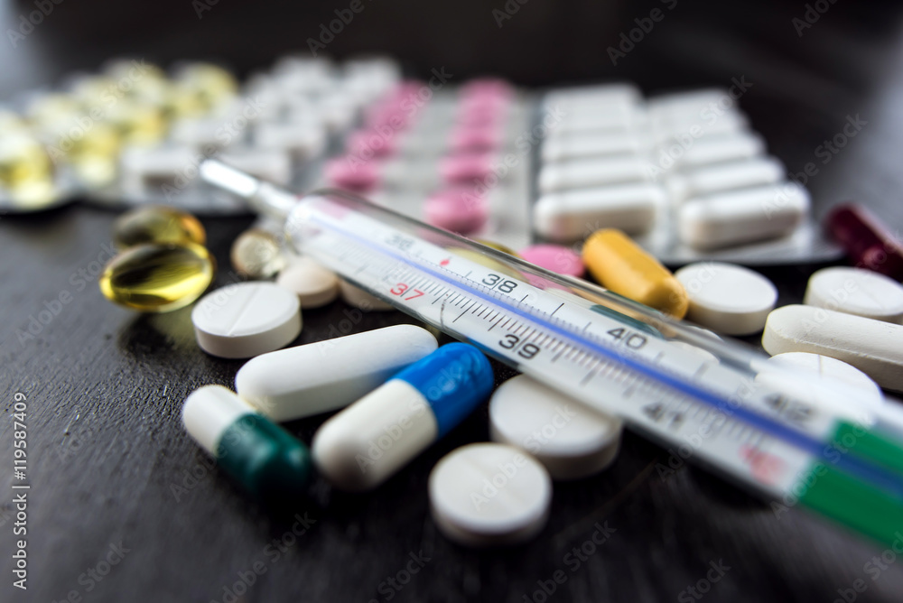 Closeup of pills and thermometer Closeup of pills and thermometer
