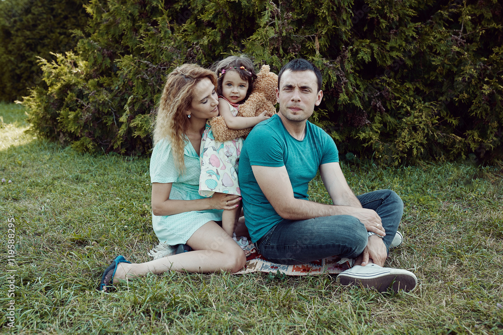 Fototapeta premium Happy young family spending time together outside in green nature.