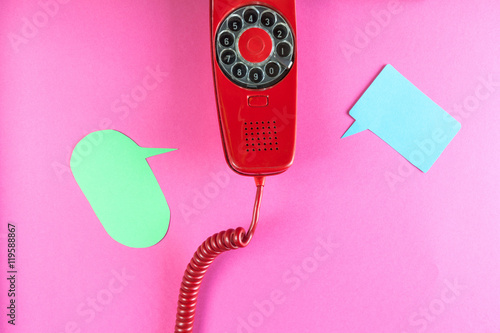 Vintage red phone and speech ballons