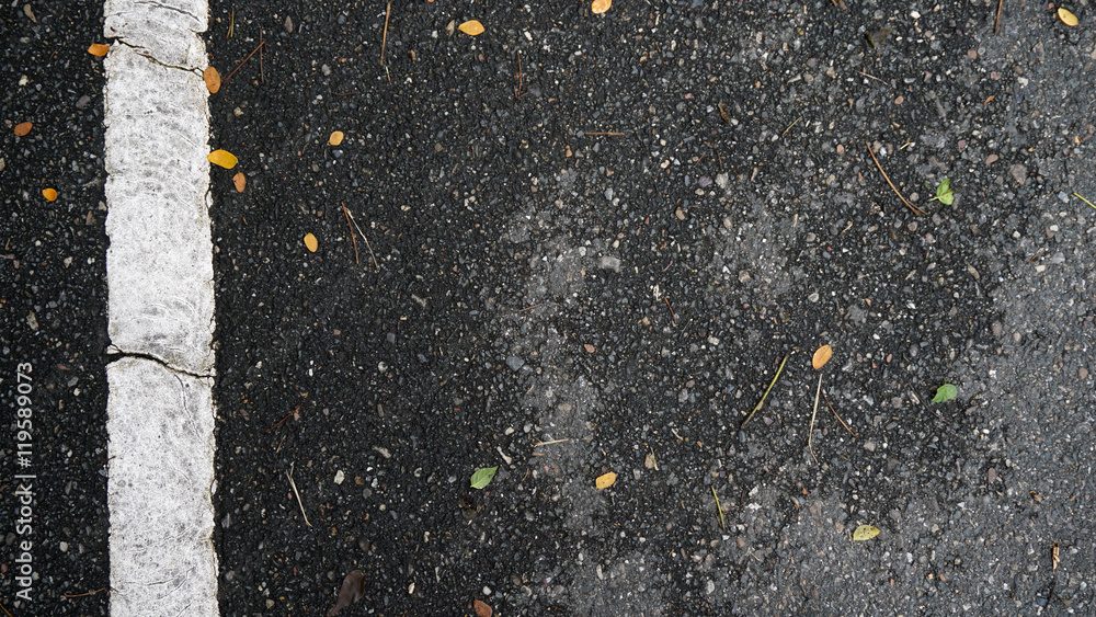 Fototapeta premium asphalt road texture with orange falling leaves