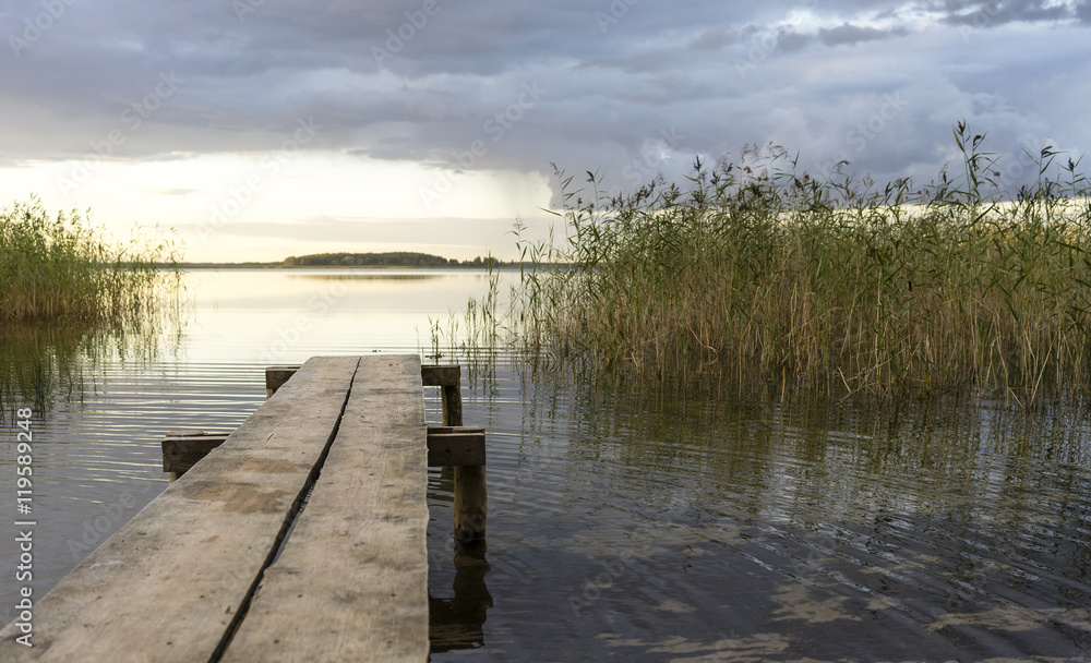 Naklejka premium pier on the lake among the reeds