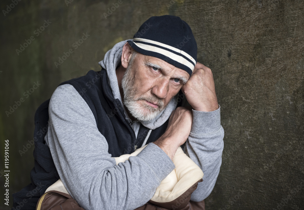 Portrait image of a mature man looking upset and worried on a stone background Portrait image of a mature man looking upset and worried on a stone background