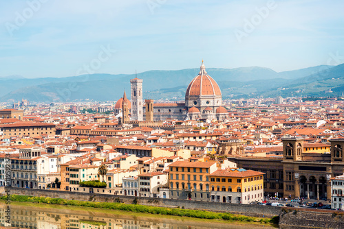 Florence aerial cityscape view from Michelangelo square on the old town with famous cathedral church and river in Italy
