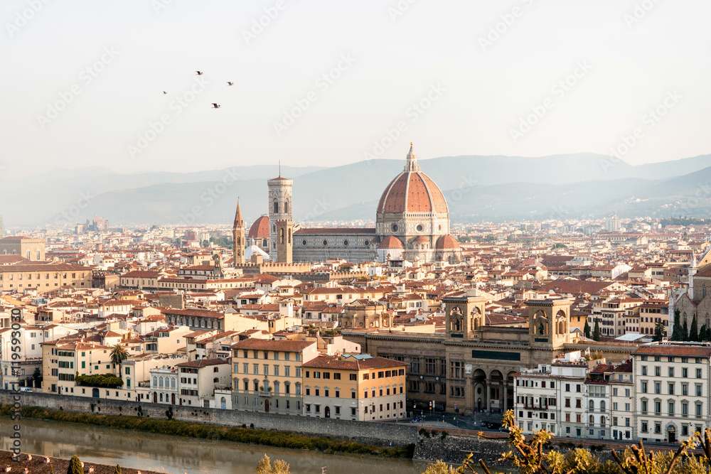 Florence aerial cityscape view from Michelangelo square on the old town with famous cathedral church and river in the morning in Italy