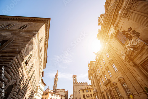 Florence cityscape view with Badia Fiorentina church tower and San Firenze complex on the sunset in Italy photo