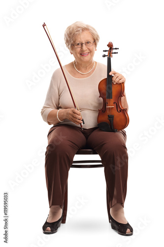 Woman holding a violin and a bow