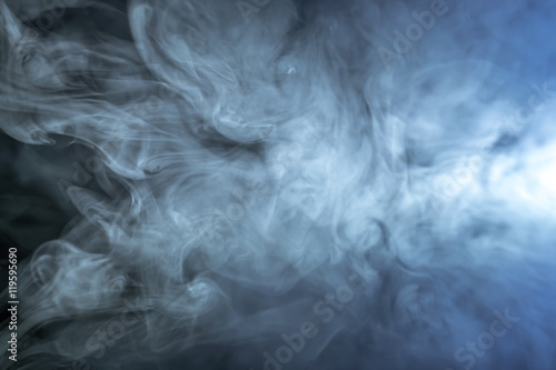 The stream of thick smoke on a dark background © realstock1