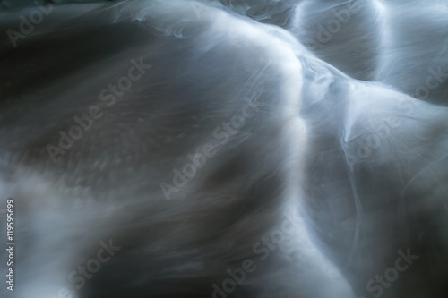 The stream of thick fume  smoke  on a dark background
