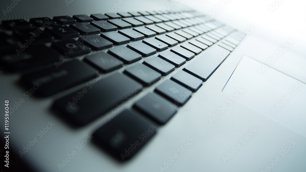The laptop with the black keyboard, close up view