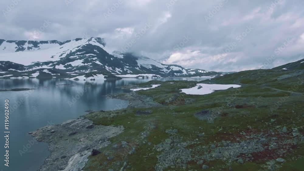 Scenic aerial view of Styggevatnet with snowy mountains on the background. Scenic aerial view of Styggevatnet with snowy mountains on the background.