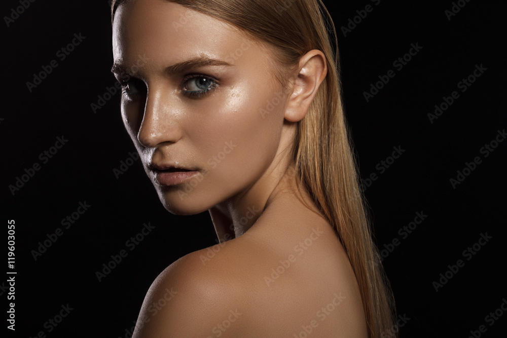 Young and beautiful woman washing her face. Woman on black backg Young and beautiful woman washing her face. Woman on black backg