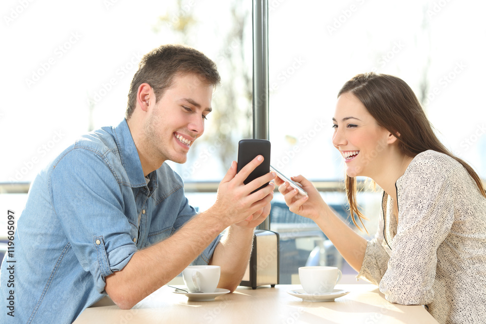 Couple sharing media content with smart phones Couple sharing media content with smart phones