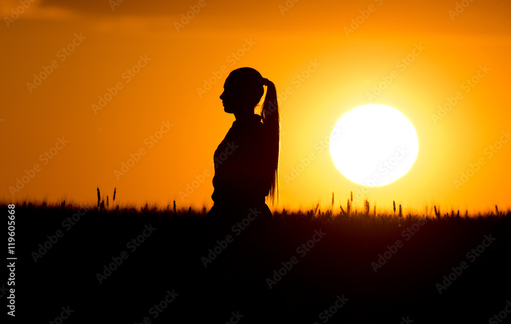 Silhouette of girl in wheat field