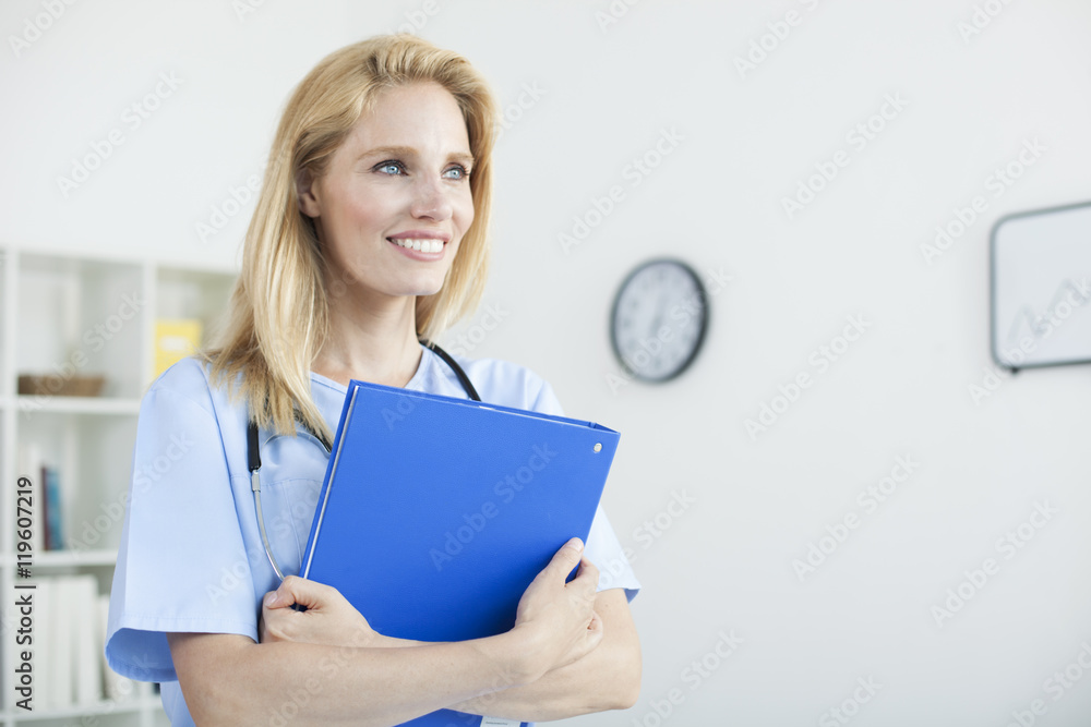 Young beautiful female doctor and practitioner working at desk