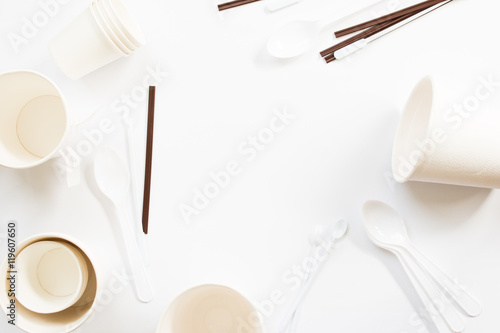Paper cup and tea spoons background.