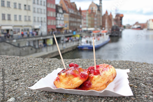 Sheep fried cheese with cranberry sauce. Street food on the embankment in Gdansk. Polish cuisine.
