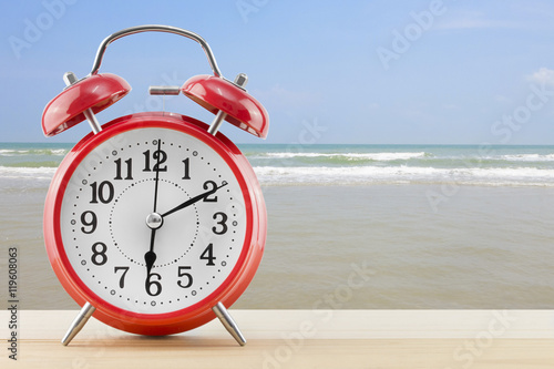alarm clock with sea and beach background.