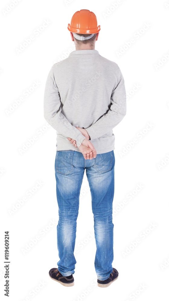 Backview of an engineer in construction helmet stands. Standing young guy. Rear view people collection. backside view of person. Isolated over white background. Backview of an engineer in construction helmet stands. Standing young guy. Rear view people collection. backside view of person. Isolated over white background.