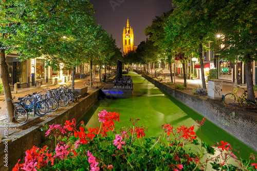 Oude Delft canal and leaning tower of Gothic Protestant Oude Kerk church at night, Delft, Holland, Netherlands