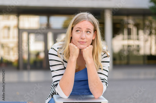 Doubtful teenager leaning on knees