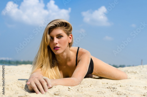 Seductive woman on white sand