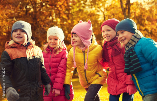 group of happy children having fun in autumn park