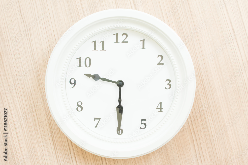 White clock on wood wall White clock on wood wall