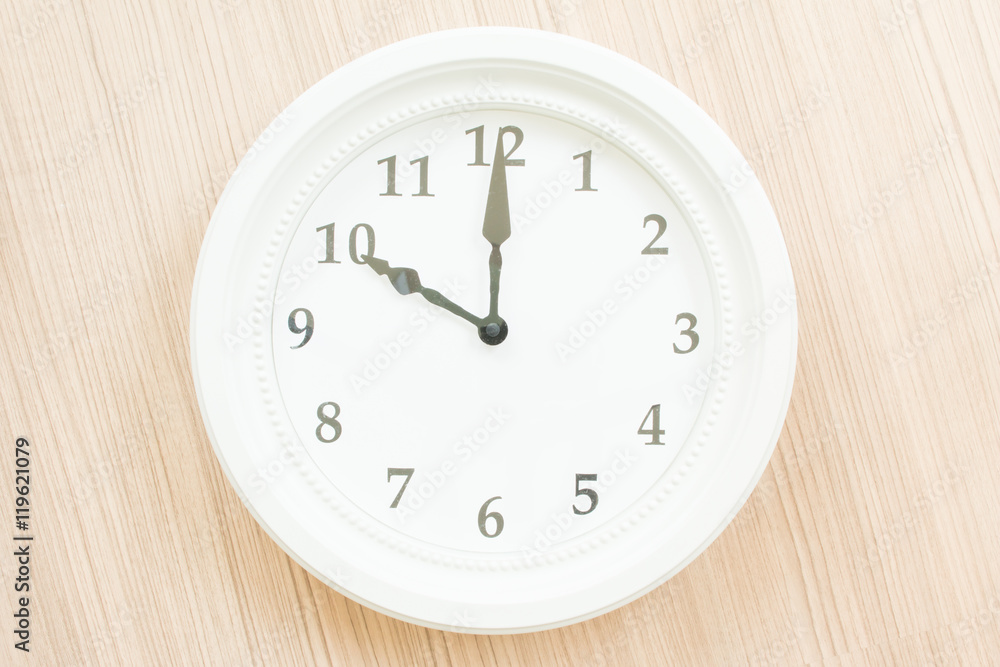 White clock on wood wall