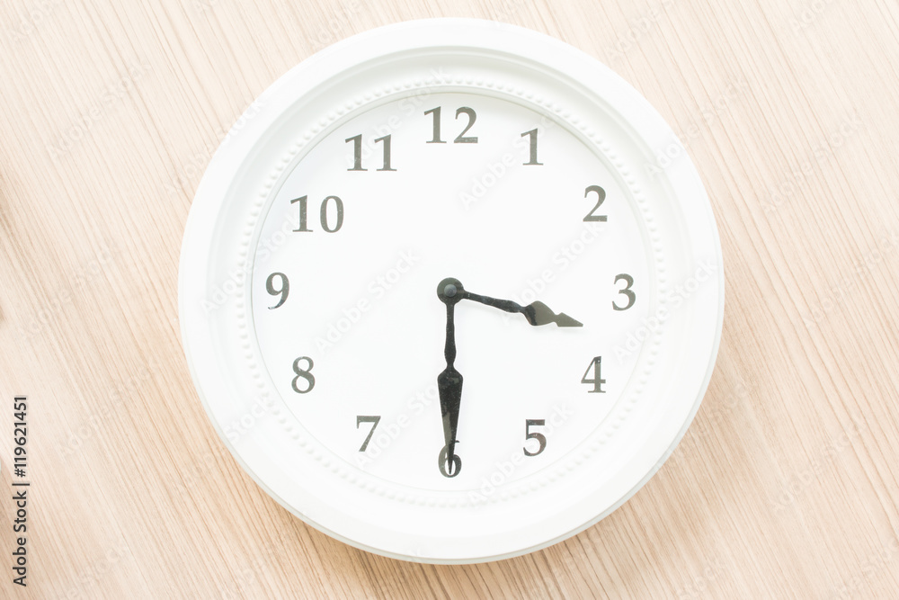 White clock on wood wall White clock on wood wall