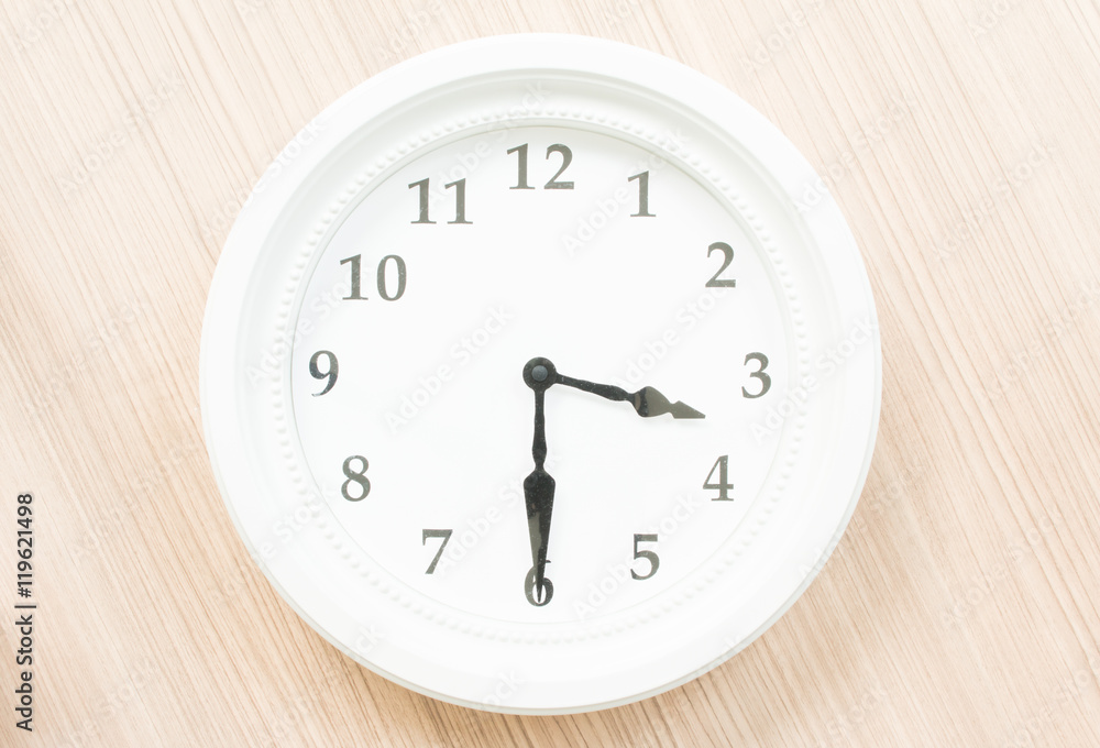 White clock on wood wall White clock on wood wall