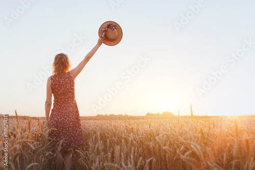 goodbye or parting background, farewell, woman waving hand in the field photo