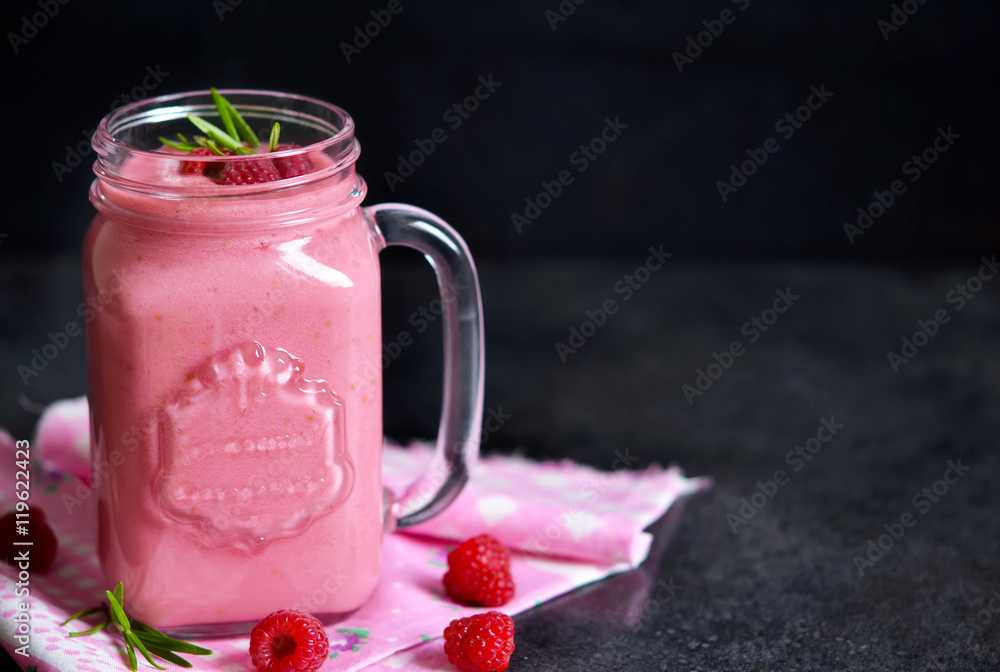 Summer cool drink, a smoothie with raspberry and peach on a blac Summer cool drink, a smoothie with raspberry and peach on a blac