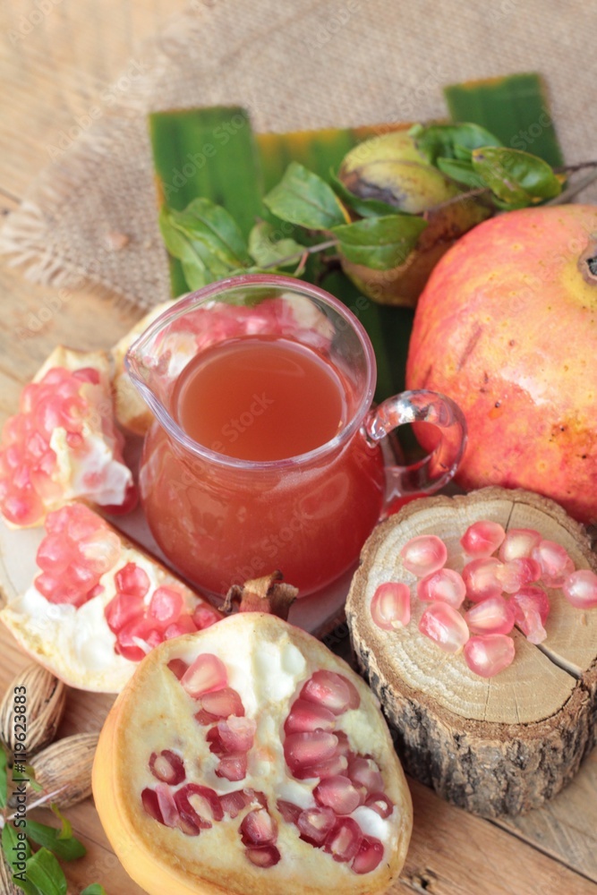 Ripe pomegranates with juice on wood background. Ripe pomegranates with juice on wood background.
