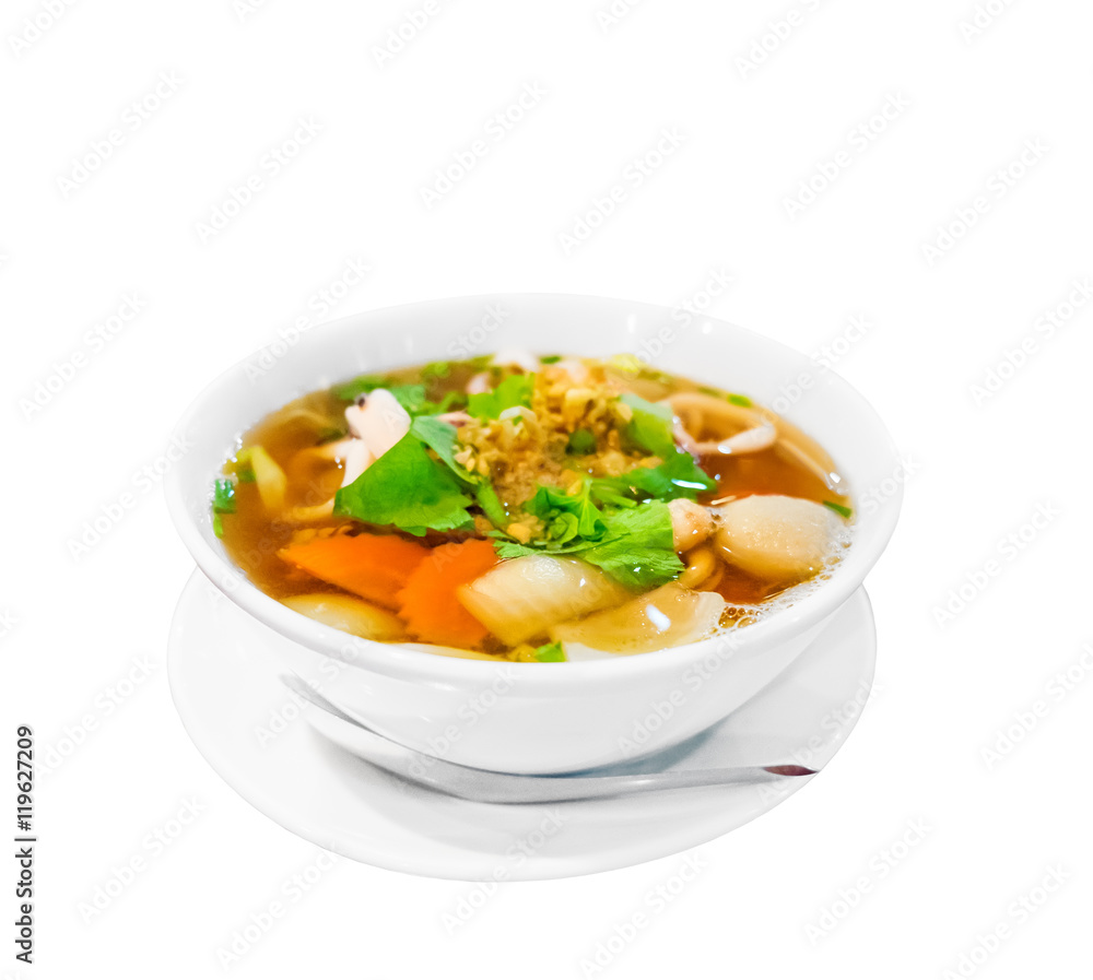Hot and spicy Thai Dishes. A savoury thick soup made with squid rings, spices and vegetables and crushed peanuts isolated on white background. Selective focus Hot and spicy Thai Dishes. A savoury thick soup made with squid rings, spices and vegetables and crushed peanuts isolated on white background. Selective focus