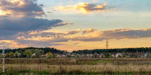Panoramic view of modern rural Ukrainian landscape in autumn. Countryside farm and fields and dramatic sunset sky, Irpin, Ukraine.