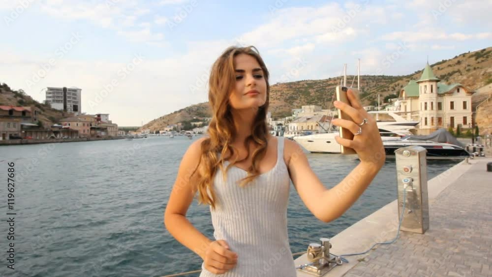 happy young sexy girl selfie is photographed on a mobile phone on vacation happy young sexy girl selfie is photographed on a mobile phone on vacation