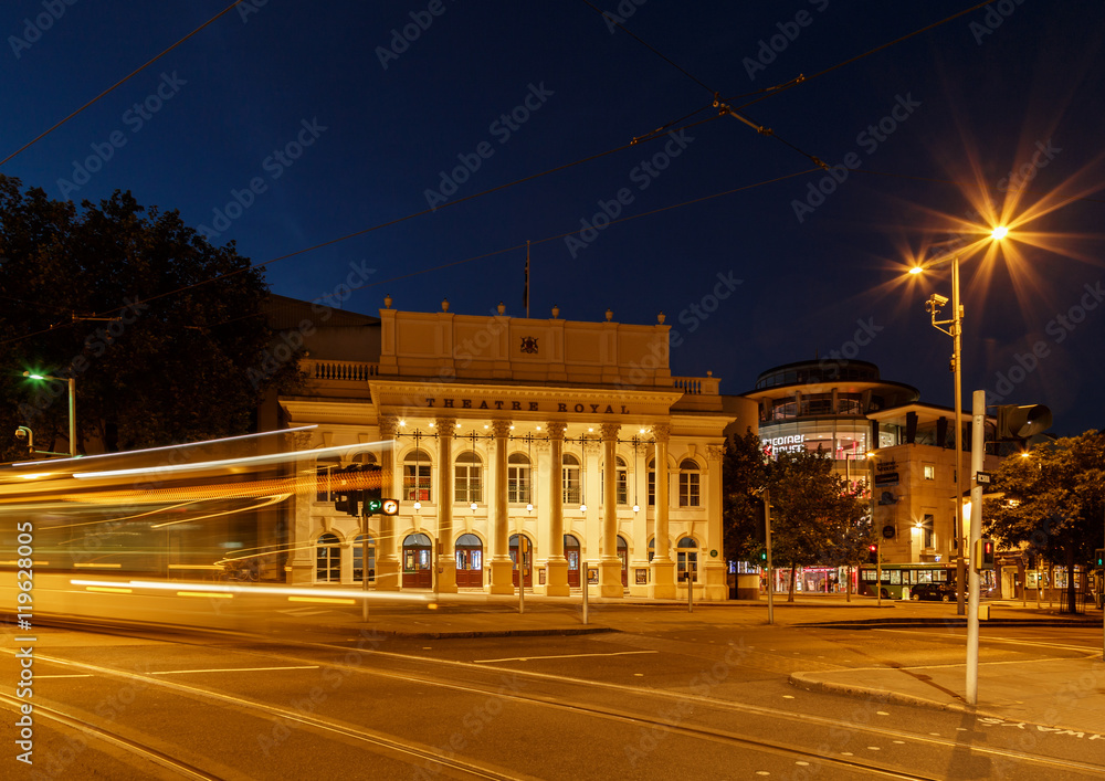NOTTINGHAM, ENGLAND - AUGUST 30: Wide view of the Theatre Royal. Lights of a 'NET' tram are caught as traffic trails. In Nottingham, England. On 30th August 2016.