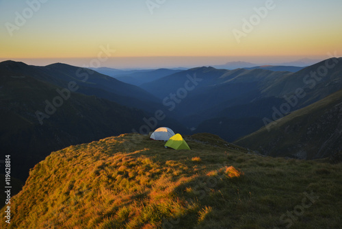 Tourist tents camp in the wildness of the mountains, view at sunrise