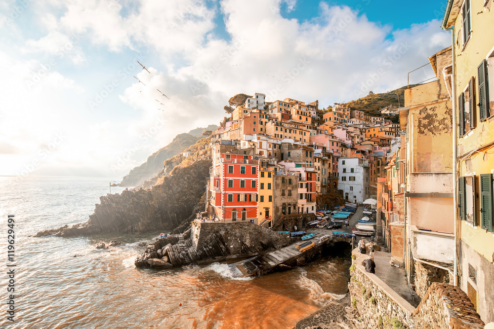 Landscape view on the old coastal famous town Riomaggiore in the small valley in the Liguria region of Italy