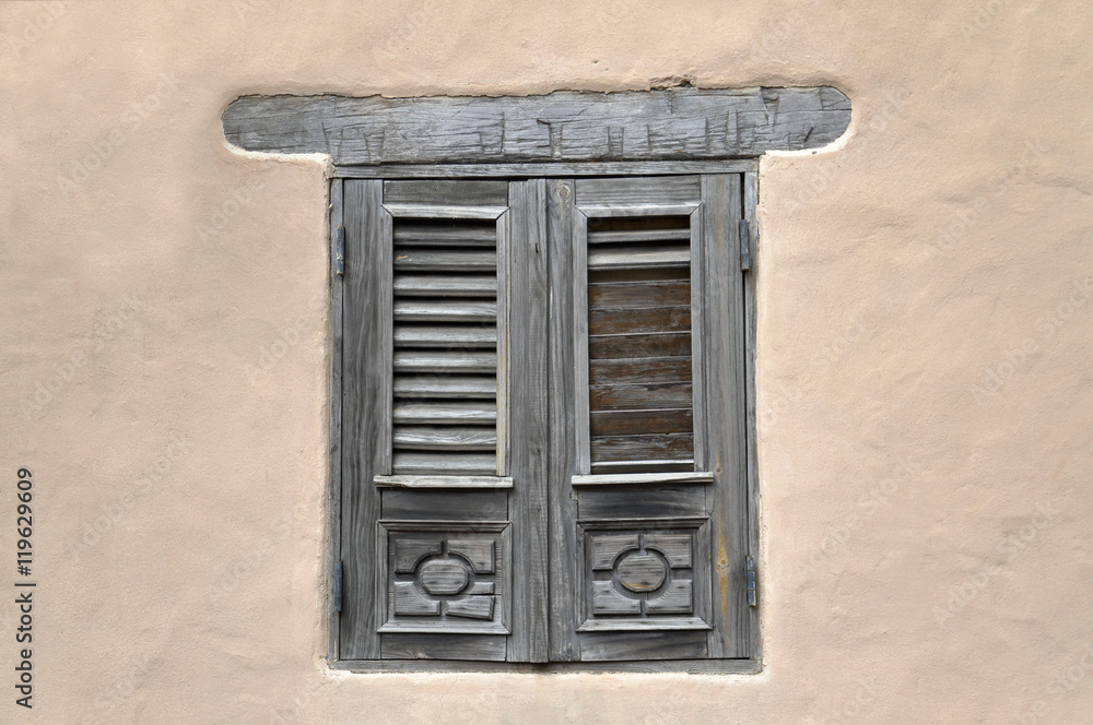 Closed window and shutter on ancient wall