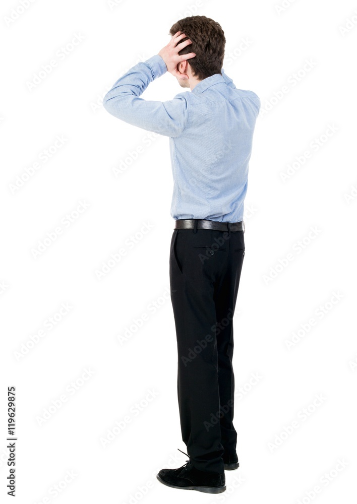 Businessman defends his hands on top of something. curly-haired businessman in light shirt in horror clutched at his head. Businessman defends his hands on top of something. curly-haired businessman in light shirt in horror clutched at his head.
