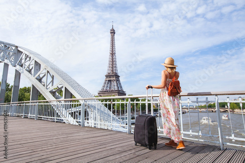 Photography travel to Paris, Europe tour, woman with suitcase near Eiffel Tower, France