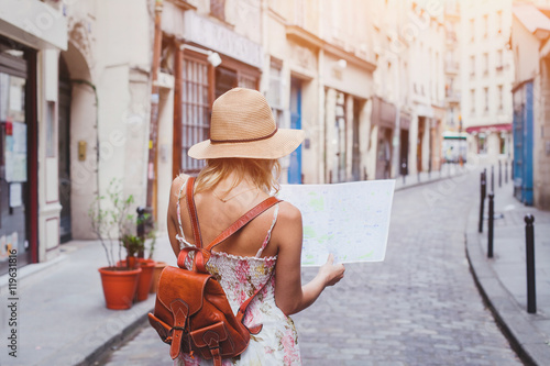 Obraz na plátne travel guide, tourism in Europe, woman tourist with map on the street