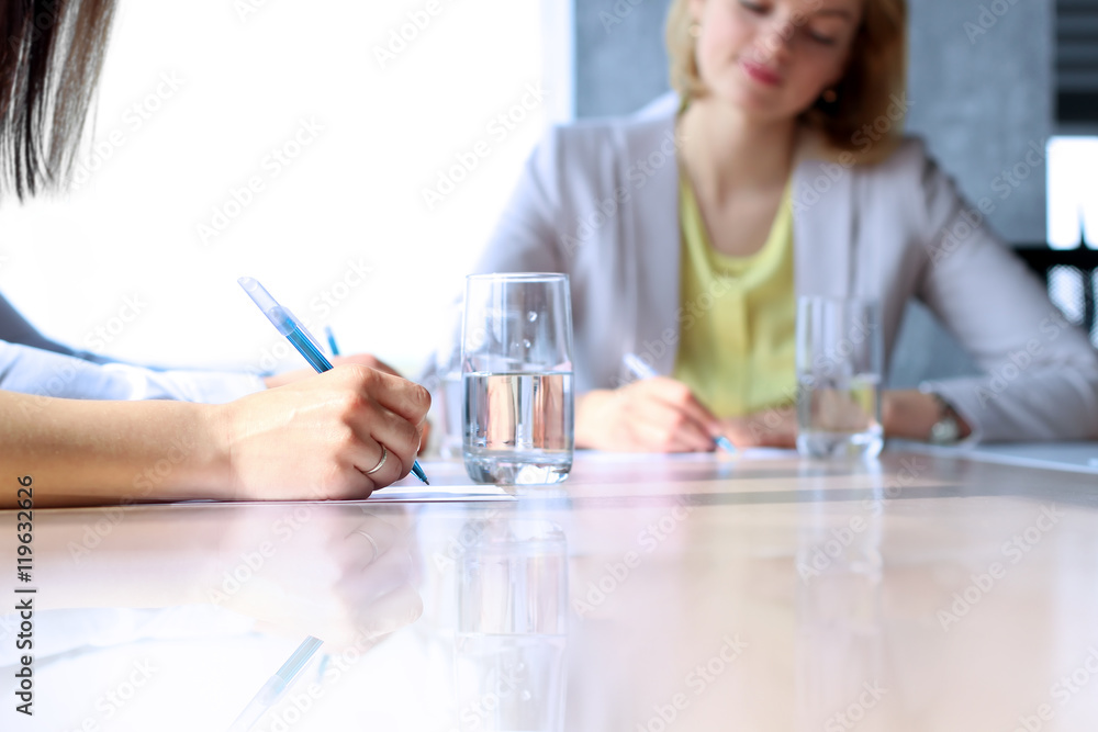Close-up Of Business women Analyzing data in the office Close-up Of Business women Analyzing data in the office