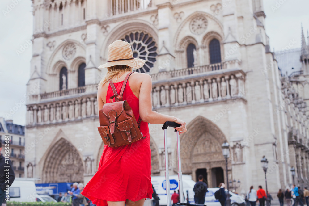travel in Europe, gothic architecture of catholic church, tourist looking at Notre Dame cathedral in Paris, France