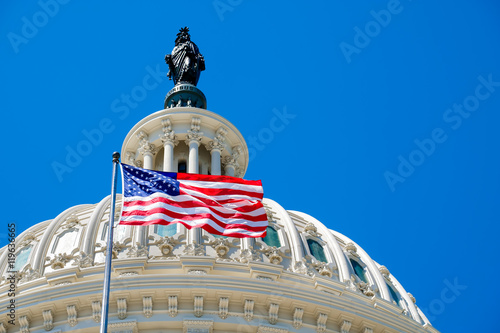 American flag waving in front of the Capitol in Washington D.C.