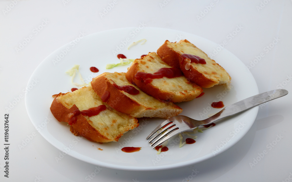 Garlic and herb bread slices with tomato sauce in white plate. Garlic and herb bread slices with tomato sauce in white plate.