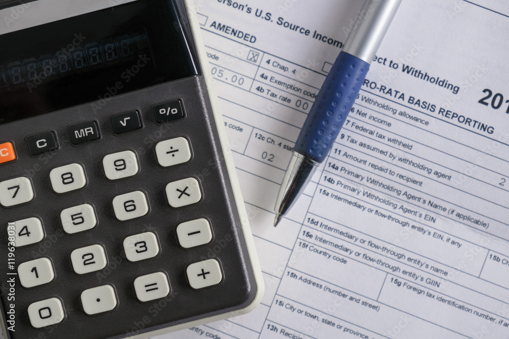 Calculator / View of calculator on the table with tax documents. Calculator / View of calculator on the table with tax documents.