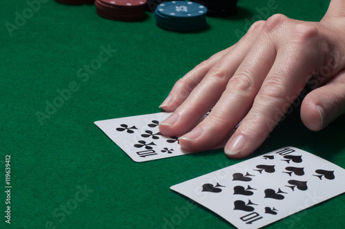 two cards of the player's hand at the game table with chips
