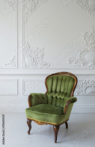 elegant green armchair in luxury clean bright white interior